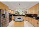 Spacious kitchen featuring stainless steel appliances, black granite counters, and an island at 1077 Carriage Hills Dr, Boulder, CO 80302