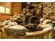 Small waterfall with snow-covered rocks and landscaping at 1077 Carriage Hills Dr, Boulder, CO 80302