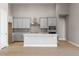 Modern kitchen with island, stainless steel appliances, and light gray cabinets at 3893 Freestone Pt, Castle Rock, CO 80108