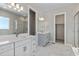 Elegant bathroom with double vanity, marble tile, and soaking tub at 3893 Freestone Pt, Castle Rock, CO 80108