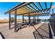 Community grilling area with picnic tables and pergola at 3893 Freestone Pt, Castle Rock, CO 80108