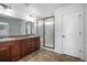 Modern bathroom with dual sinks, granite countertops, and glass shower doors at 7844 S Elk St, Aurora, CO 80016