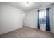 Another view of the comfortable bedroom with plush carpet and blue curtains at 7844 S Elk St, Aurora, CO 80016