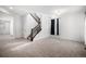 Bright living room with plush carpet and a staircase at 7844 S Elk St, Aurora, CO 80016