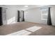 Large, bright main bedroom with plush carpet and multiple windows at 7844 S Elk St, Aurora, CO 80016