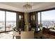 Elegant dining area with a round table, city views, and a modern chandelier at 1133 14Th St # 1800, Denver, CO 80202