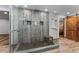 Walk-in shower with stone tile and glass enclosure at 36725 Forest Trl, Elizabeth, CO 80107