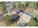 An aerial view of a house with a tiled roof, garage, driveway, and surrounding trees at 5519 Ponderosa Dr, Parker, CO 80134