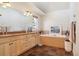 Bathroom with double vanity, soaking tub, and tiled floors at 5519 Ponderosa Dr, Parker, CO 80134