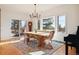 Dining room with wood floors, large windows, and access to a deck at 5519 Ponderosa Dr, Parker, CO 80134