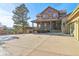 Front exterior view of a house with stone accents, a covered porch, and a tree-lined driveway at 5519 Ponderosa Dr, Parker, CO 80134
