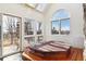 Octagonal hot tub in a bright sunroom with large windows and scenic views at 5519 Ponderosa Dr, Parker, CO 80134