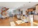 Kitchen with breakfast bar, hardwood floors, spiral staircase, and an open floor plan at 5519 Ponderosa Dr, Parker, CO 80134