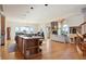 Open-concept kitchen and living area with vaulted ceilings, a fireplace, and large windows at 5519 Ponderosa Dr, Parker, CO 80134