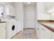 Laundry room with washer, dryer, and ample counter space at 5519 Ponderosa Dr, Parker, CO 80134