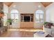Living room with vaulted ceilings, built-in entertainment center, and stone fireplace at 5519 Ponderosa Dr, Parker, CO 80134