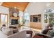Living room with wood floors, stone fireplace, and large windows at 5519 Ponderosa Dr, Parker, CO 80134