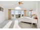Main bedroom with vaulted ceilings, large windows, and access to a balcony at 5519 Ponderosa Dr, Parker, CO 80134