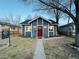 Charming bungalow with red door and landscaped yard at 4208 S Sherman St, Englewood, CO 80113