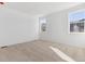 Bright bedroom with neutral colored carpet and two windows at 9723 Ceylon St, Commerce City, CO 80022