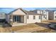Rear view of house showcasing patio and yard at 9723 Ceylon St, Commerce City, CO 80022