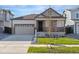 House exterior featuring a two-car garage and well-manicured lawn at 9723 Ceylon St, Commerce City, CO 80022