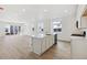Open concept kitchen with island, stainless steel appliances, and white cabinets at 9723 Ceylon St, Commerce City, CO 80022