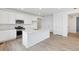 Open concept kitchen with white cabinets and large island at 9723 Ceylon St, Commerce City, CO 80022