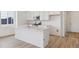 Modern kitchen with a large island and white cabinetry at 9723 Ceylon St, Commerce City, CO 80022