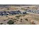 Aerial view of a neighborhood with houses and open space at 3077 Carabiner St, Castle Rock, CO 80108