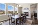 Dining area with a fireplace, large windows, and a farmhouse table at 3077 Carabiner St, Castle Rock, CO 80108