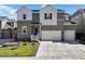 Two-story house with gray siding, white accents, and a two-car garage at 3077 Carabiner St, Castle Rock, CO 80108