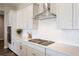 Modern kitchen with gas cooktop and white cabinets at 3077 Carabiner St, Castle Rock, CO 80108