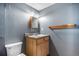 Simple bathroom with wood vanity and gray walls at 11241 W 104Th Ave, Broomfield, CO 80021