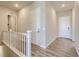 Upper level hallway with light gray walls, white doors, and hardwood floors at 13873 Bunny Hop Ln, Parker, CO 80134