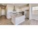 Modern kitchen with granite island, white cabinets, and stainless steel appliances at 13873 Bunny Hop Ln, Parker, CO 80134