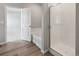 Bathroom featuring a soaking tub, walk-in shower and vinyl plank flooring at 2225 Alyssa St, Fort Lupton, CO 80621