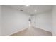 Empty and bright basement room with carpeted floor and door at 596 Fox Hunt Cir, Highlands Ranch, CO 80126