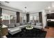 Spacious living room with large sectional sofa and big windows at 10226 Worchester St, Commerce City, CO 80022