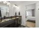 Double vanity bathroom with granite countertops and view to bedroom at 10226 Worchester St, Commerce City, CO 80022