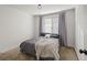 Cozy bedroom with gray bedding and window coverings at 10226 Worchester St, Commerce City, CO 80022
