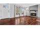 Bright living room with hardwood floors, fireplace, and large windows at 16142 E Oxford Dr, Aurora, CO 80013