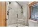Spa-like shower with glass enclosure, pebble floor, and modern fixtures at 3864 Valley Dr, Evergreen, CO 80439
