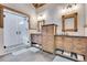Bathroom with double vanity, walk-in shower, and hexagon tile at 3864 Valley Dr, Evergreen, CO 80439