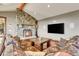 Living room with stone fireplace and comfortable seating at 3864 Valley Dr, Evergreen, CO 80439