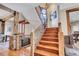 Elegant wooden staircase with metal railing and rustic wood beams at 3864 Valley Dr, Evergreen, CO 80439
