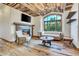 Cozy living room with fireplace, wood floors and large window at 3864 Valley Dr, Evergreen, CO 80439