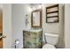 Bathroom with rustic vanity and decorative mirror at 3864 Valley Dr, Evergreen, CO 80439