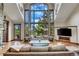 Bright living room with hardwood floors, large windows, and comfortable seating at 3864 Valley Dr, Evergreen, CO 80439
