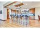 Gourmet kitchen with island seating, stainless steel appliances, and rustic wood cabinets at 3864 Valley Dr, Evergreen, CO 80439